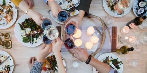 people toasting with wine and food